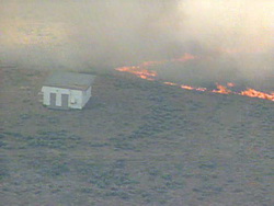 A grass fire burns near Wiggins, CO.