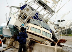 A TV cameraman tapes the wreckage left by Hurricane Ike In Galveston.  Bob Pearson / EPA