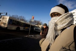 Erin Mooty tries to stay warm as she waits for a bus Monday.  Image courtesy Darin McGregor, The Rocky.